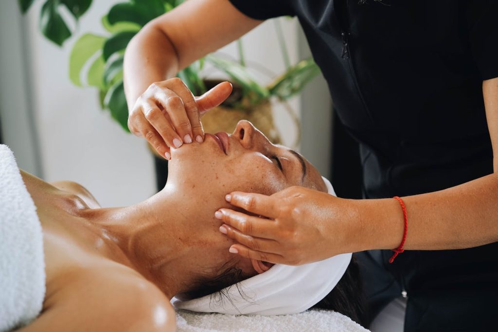 close-up-shot-of-a-woman-having-a-face-massage-9335961 Enjoy a calming facial massage promoting wellness and relaxation at a luxurious spa.